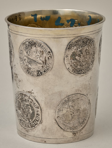 Kubek srebrny dekorowany emblematami z wizerunkami królewskimi.