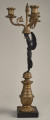 Kandelabr trzyświecowy z postacią uskrzydlonej Nike na postumencie, trzymającej ramiona świecznika.Bok prawy