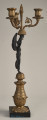 Kandelabr trzyświecowy z postacią uskrzydlonej Nike na postumencie, trzymającej ramiona świecznika. Bok lewy