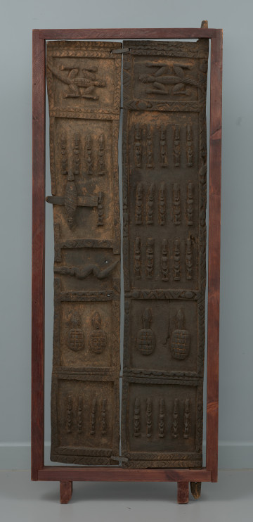 drzwi - Ujęcie z przodu. Dwuczęściowe drewniane drzwiczki do spichlerza. Całość udekorowana płaskorzeźbami.
