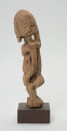 rzeźba - Ujęcie z prawego boku; Figura - postać mężczyzny w pozycji stojącej. O płci świadczy bródka. Części ciała płaskorzeźbione z bryły. Forma uproszczona, zgeometryzowana. Związana z kultem przodków, przeznaczona na ołtarz przodków.