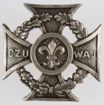 ML/MART/327 - Krzyż harcerski 4-ramienny wykonany z metalu, na środku lilijka harcerska, krzyż otaczają liście wawrzynu; napis na bocznych ramionach 