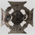 ML/MART/327 - Krzyż harcerski 4-ramienny wykonany z metalu, na środku lilijka harcerska, krzyż otaczają liście wawrzynu; napis na bocznych ramionach 