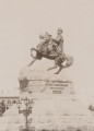 zbliżenie na pomnik ukazany od lewej strony. Na kamiennym cokole hetman Chmielnicki na koniu. Ubrany w płaszcz i czapkę z piórami i broszą; u boku szabla