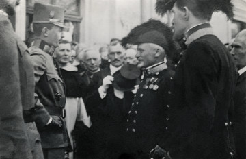 Na zdjęciu znajduje sie gruma mężczyzn, na pierwszym planie wyróżnia się czeterech mężczyzn w mundurach stojacych na przeciwko siebie.