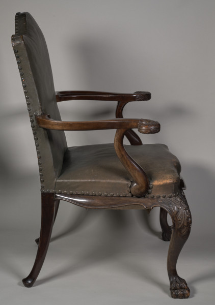 Fotel wsparty na czterech wygiętych nogach zakończonych u dołu formą łapy zwierzęcej, u nasady rzeźbionych w motywy roślinne